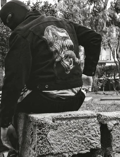 Hand-painted design on the back of a worn denim jacket